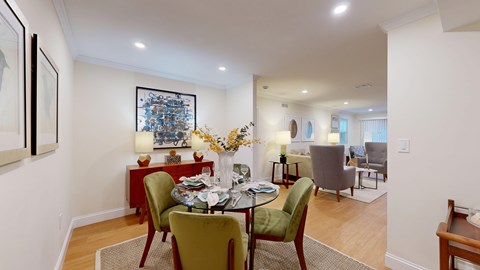 A dining room with a table set for four.