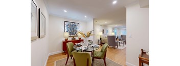 A dining room with a table set for four.