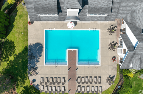 An aerial view of a swimming pool surrounded by chairs.