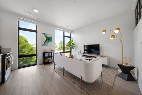 a living room with a white couch and a tv