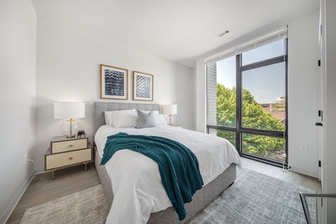 a bedroom with a large bed and a large window