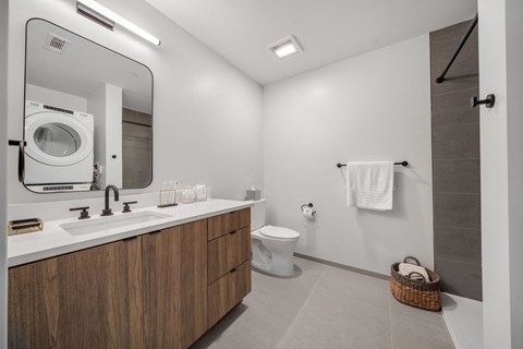 Bathroom Finishes featuring full size washer and dryer