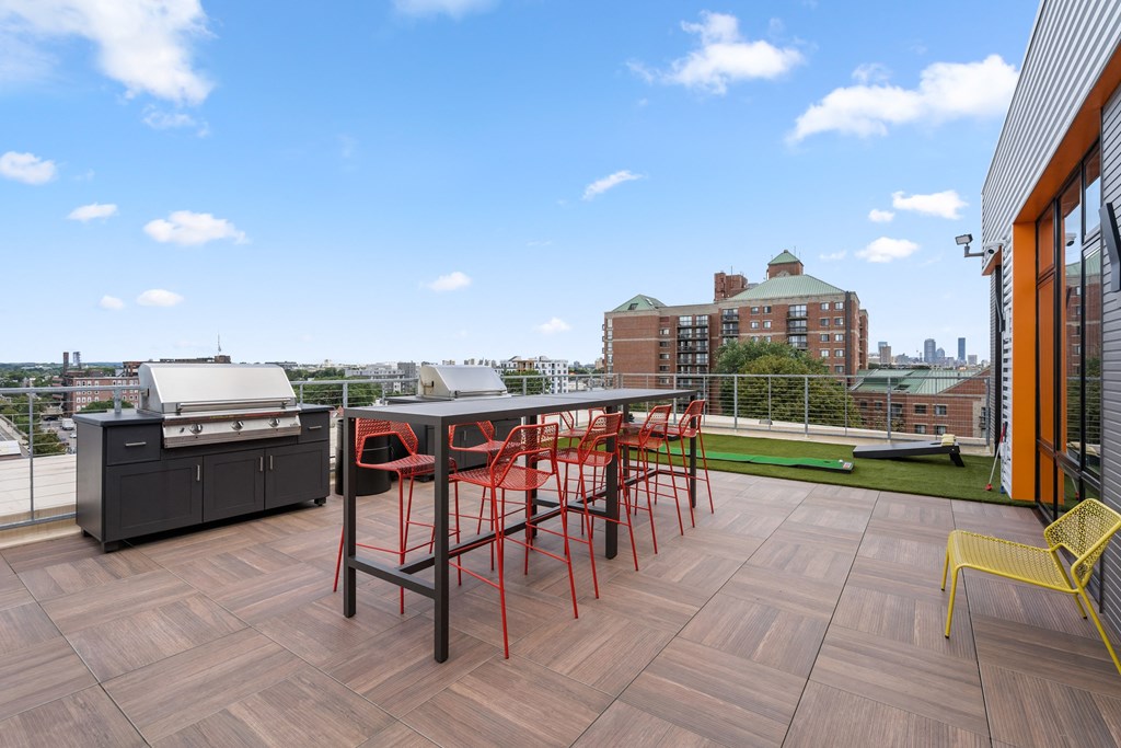 Roof deck featuring grills, fire pit, and lounge seating