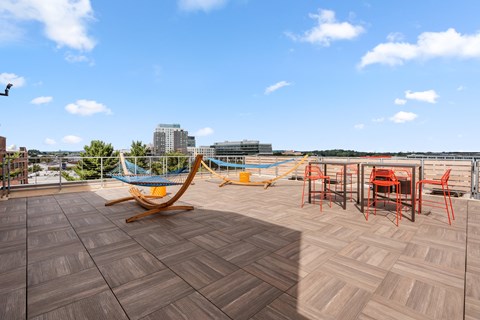Sundeck featuring tables, yard games, and hammocks