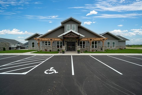 A parking lot with a handicap parking space in front of a building.