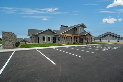 A large building with a parking lot in front of it.
