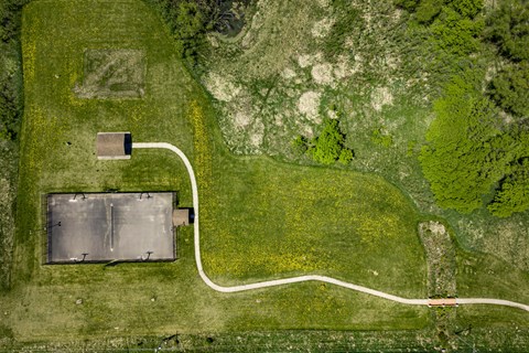 A large open field with a white line running through it.