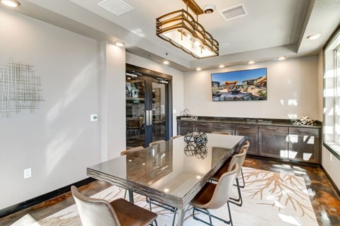 A modern dining room with a glass table and chairs.