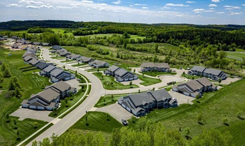 A bird's eye view of a residential area with houses and greenery.