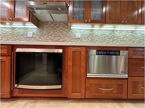 A modern kitchen with wooden cabinets and a stainless steel dishwasher.