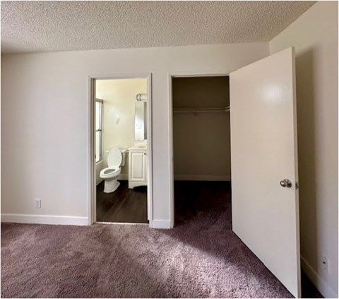 A room with a toilet in the bathroom.