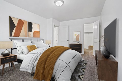 A bedroom with a large bed and a painting on the wall.
