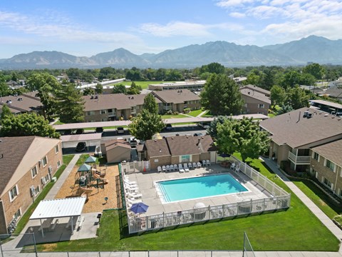 A large swimming pool surrounded by a fence in a residential area.