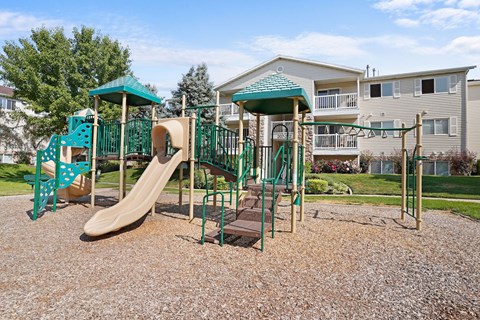 A playground with a slide, swings, and a climbing frame.