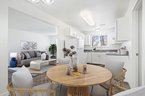 A modern living room with a round wooden table and chairs.