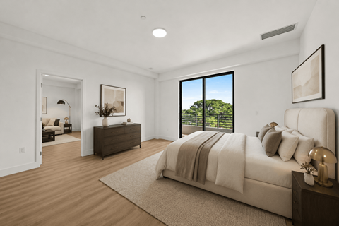 A bedroom with a large bed and a dresser with a mirror.