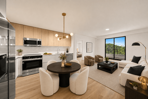 A modern kitchen with a dining table and chairs.