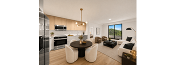 A modern kitchen with a dining table and chairs.