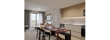A modern kitchen with a dining table set for two.