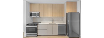 A modern kitchen with wooden cabinets and stainless steel appliances.
