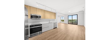 A modern kitchen with wooden cabinets and stainless steel appliances.