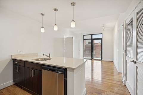 A kitchen with a sink and a dishwasher.