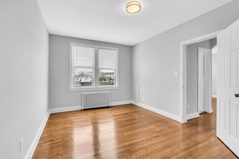 A room with a window and a radiator.