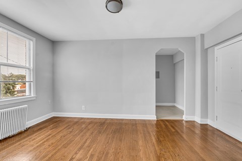 A room with wooden floors and white walls.