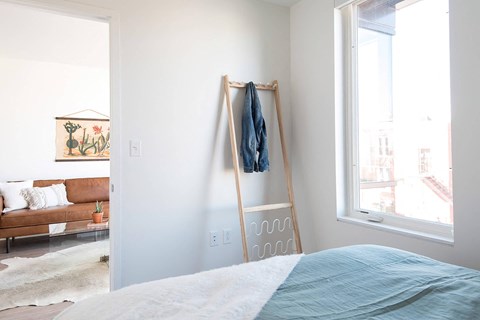 a bedroom with a bed and a window