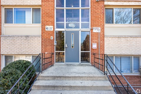 The front of a building with a glass door and a sign that says "Cleveland Crossing".