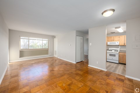 A room with wooden flooring and a window.