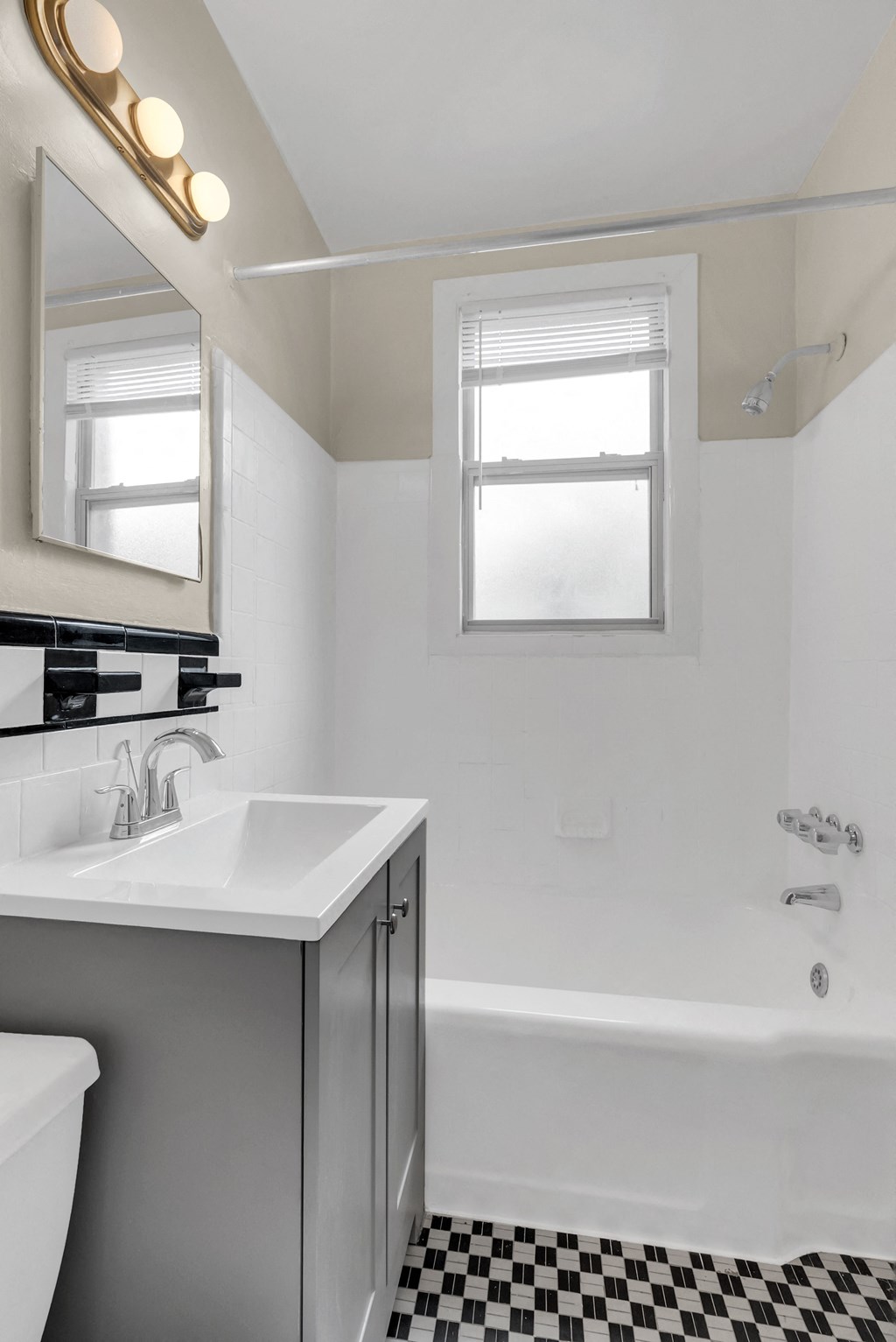 a bathroom with a sink and a bath tub and a mirror