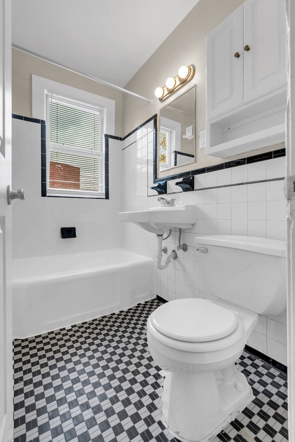 a bathroom with a white toilet and a tub and a sink