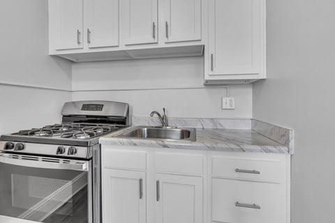 A modern kitchen with a stove and sink.
