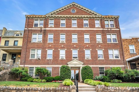 a large brick building with stairs in front of it