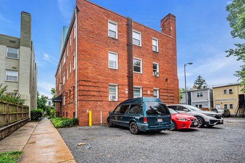 an old brick building with cars parked in front of it