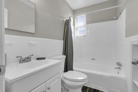 a bathroom with a toilet sink and a shower