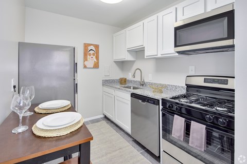 A kitchen with a stove, oven, and refrigerator.