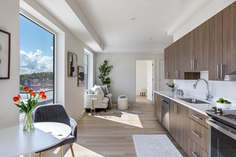 A modern kitchen with a dining table and chairs.