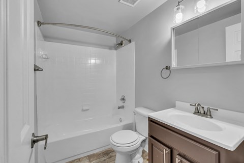 a bathroom with a shower and a sink and a toilet