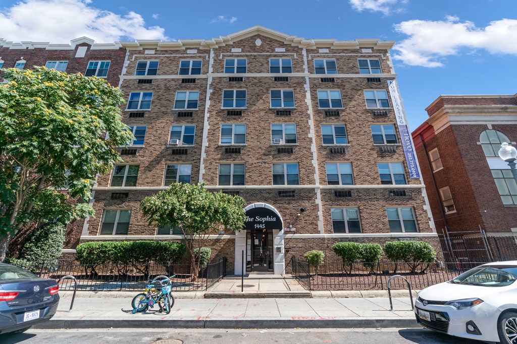 a large brick building with a front entrance and a bike parked in front