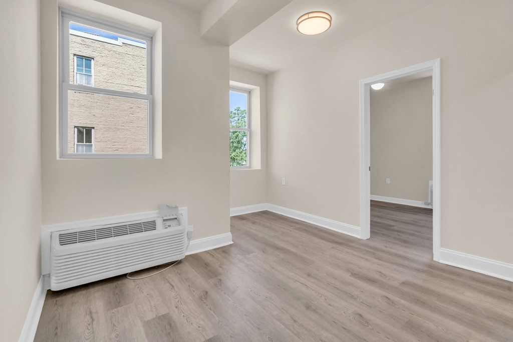 the living room and dining room in a renovated apartment