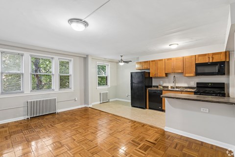 A kitchen with wooden floors and white walls.