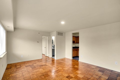 A room with a wooden floor and white walls.