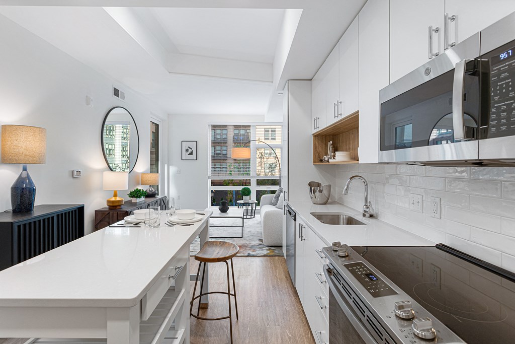 a kitchen with a white counter top and a sink