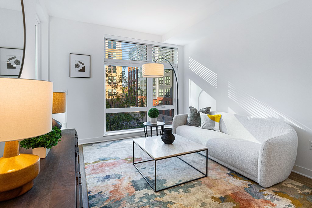 a living room with a white couch and a large window