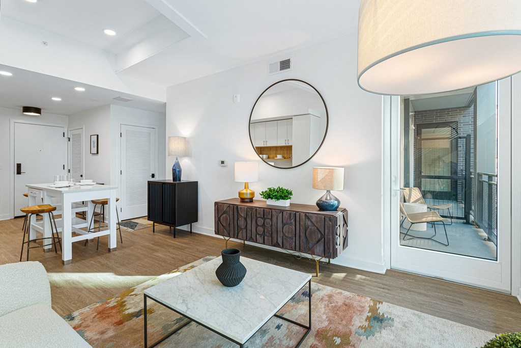 a living room with a large mirror and a dining table