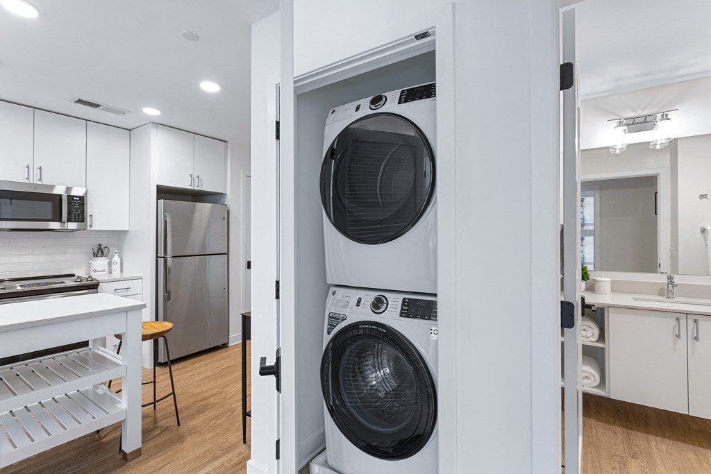 a white laundry room with a washer and a dryer