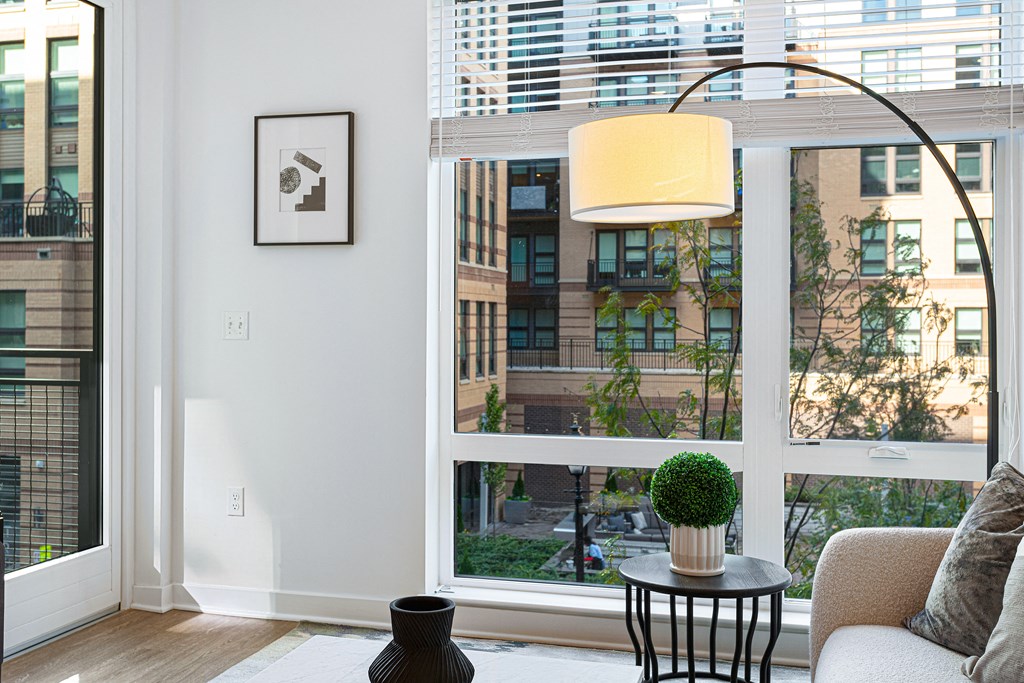 a living room with a large window and a view of the city