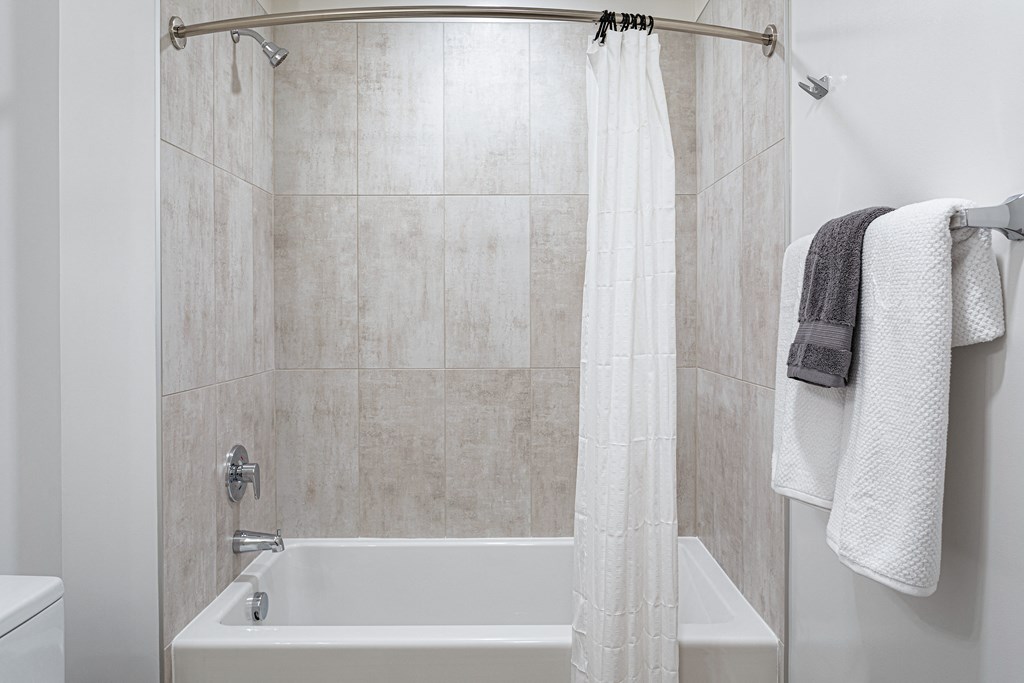 a bathroom with a shower and a sink and a bath tub